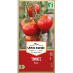 Samenbeutel mit biologischen Kirschtomatensamen von der Ferme Sainte Marthe mit reifen roten Früchten an der Pflanze